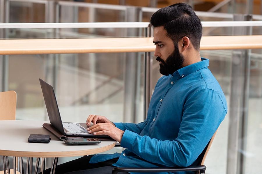 Male student types on his laptop